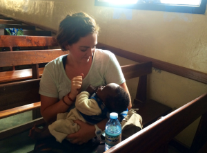 Allí Newell holding one of the youngest members of the Bunia Evangelical Francophone Church